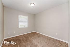 Palm Coast house for rent - the bedroom of a house with carpet and a window