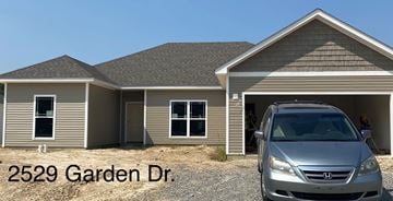 Benton house for rent - A silver Honda Civic is parked in front of a house.