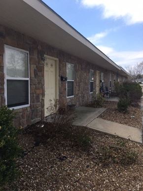 Butler apartment for rent - a brick building with a white door and a sidewalk