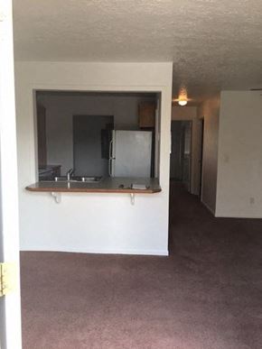 Butler apartment for rent - an empty living room with a sink and a refrigerator