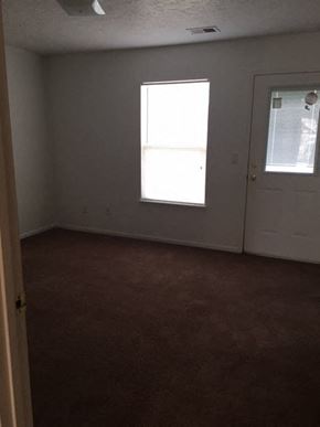 Butler apartment for rent - an empty room with a door and a window