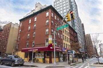 New York apartment for rent - a building on the corner of a city street with a traffic light