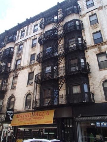 New York apartment for rent - a tall building with a fire escape on the side of it