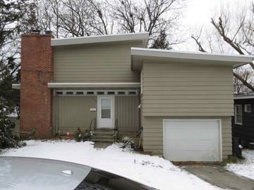 Pullman apartment for rent - A house with a white garage door and a car parked in front.