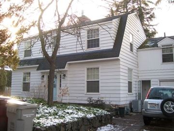 Pullman apartment for rent - A white house with a grey car parked in front.