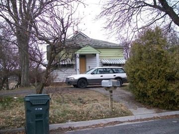 Pullman apartment for rent - A white car is parked in front of a house.