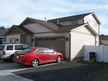 Pullman apartment for rent - A red car is parked in front of a house.