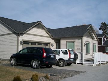 Pullman apartment for rent - A black car is parked in front of a house.