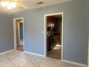 Pensacola house for rent - A kitchen is visible through an open doorway.