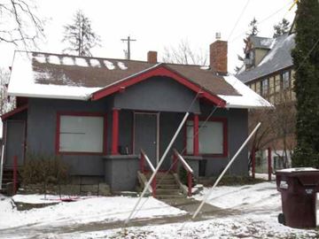 Pullman apartment for rent - A house with a red roof and a brown chimney.