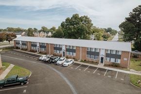 Hampton apartment for rent - an apartment building with cars parked in a parking lot
