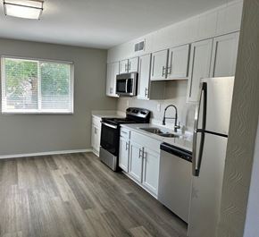 Hampton apartment for rent - a kitchen with white cabinets and a sink and a refrigerator