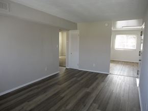 Hampton apartment for rent - an empty living room with wooden floors and white walls
