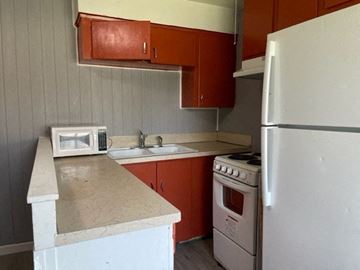 Kennewick apartment for rent - a small kitchen with a stove microwave and refrigerator