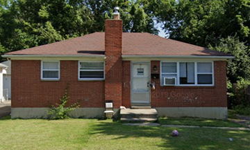 Columbus apartment for rent - a red brick house with a lawn and trees
