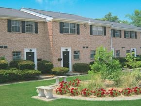 Columbus apartment for rent - a large brick building with a garden in front of it