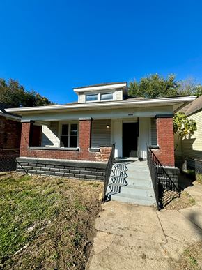 Louisville house for rent - a brick house with graffiti on the steps