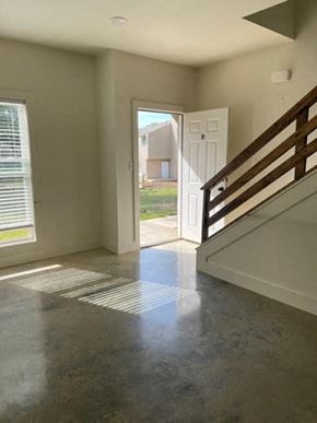 Jonesboro apartment for rent - an empty living room with a staircase and a door