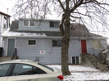 Pullman apartment for rent - a house with a red door and a car in the snow