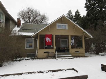 Pullman apartment for rent - A small house with a red flag hanging on the front door.