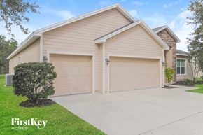 Zephyrhills house for rent - A two-car garage is attached to a house.