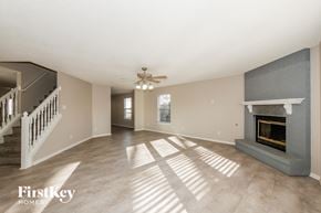 Avon house for rent - A spacious living room with a fireplace and a staircase.