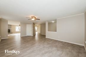 Avon house for rent - A spacious room with a ceiling fan and lighting fixture, branded with "FirstKey Homes".