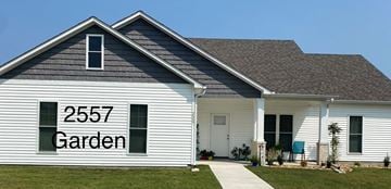 Benton house for rent - A white house with the number 2557 and the word Garden on the side.