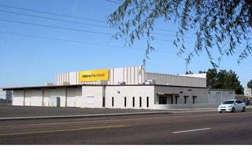 Peoria apartment for rent - a white building with a sign on it on the side of a street