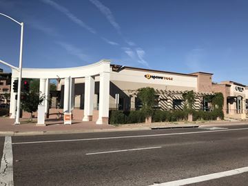 Scottsdale apartment for rent - a building with white pillars on the side of a street