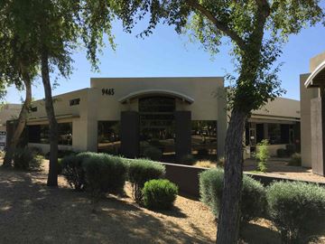 Scottsdale apartment for rent - a building with trees and bushes in front of it