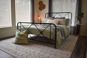 Portland apartment for rent - a bedroom with a bed and a rug and two windows