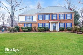 Memphis house for rent - a large brick house with blue shutters and a green lawn