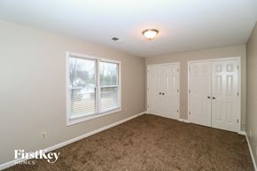 Memphis house for rent - a bedroom with carpet and two closets and a window