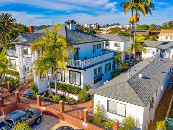 San Diego apartment for rent - an aerial view of a blue and white house with palm trees