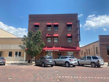 Kearney apartment for rent - a red building with three cars parked in front of it