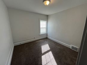 Lakewood apartment for rent - A room with a window and a floor heating vent.