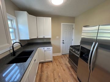 Lakewood apartment for rent - A kitchen with white cabinets and a stainless steel refrigerator.