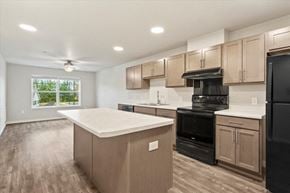 Winona apartment for rent - a kitchen with an island and a black stove and refrigerator