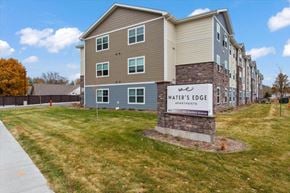 Winona apartment for rent - an apartment building with a sign that says waters edge and a sidewalk