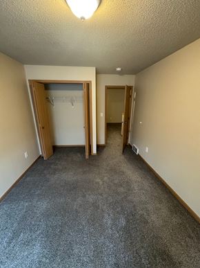 Fargo apartment for rent - A room with a grey carpet and two doors.