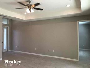 Lehigh Acres house for rent - a empty living room with a ceiling fan