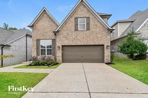 Cordova house for rent - A brick house with a garage door is for sale.