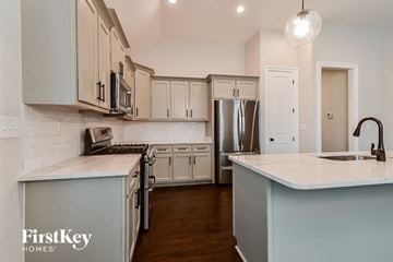 Cordova house for rent - A kitchen with a white counter top and a stainless steel refrigerator.