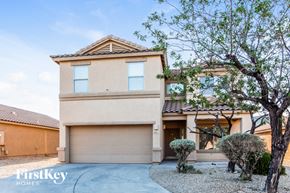 Tucson house for rent - a house with a garage and a tree in front of it