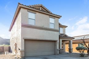 Tucson house for rent - a house with a garage door in front of it