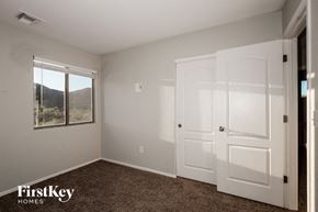 Tucson house for rent - a bedroom with two white doors and a window