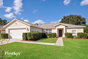 Palm Coast house for rent - a white house with a lawn and a driveway