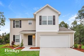 Palm Coast house for rent - a white house with black shutters and a driveway
