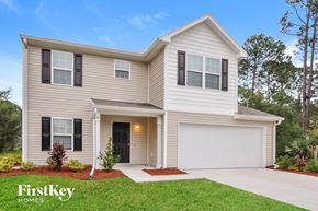 Palm Coast house for rent - a beige house with black shutters and a driveway